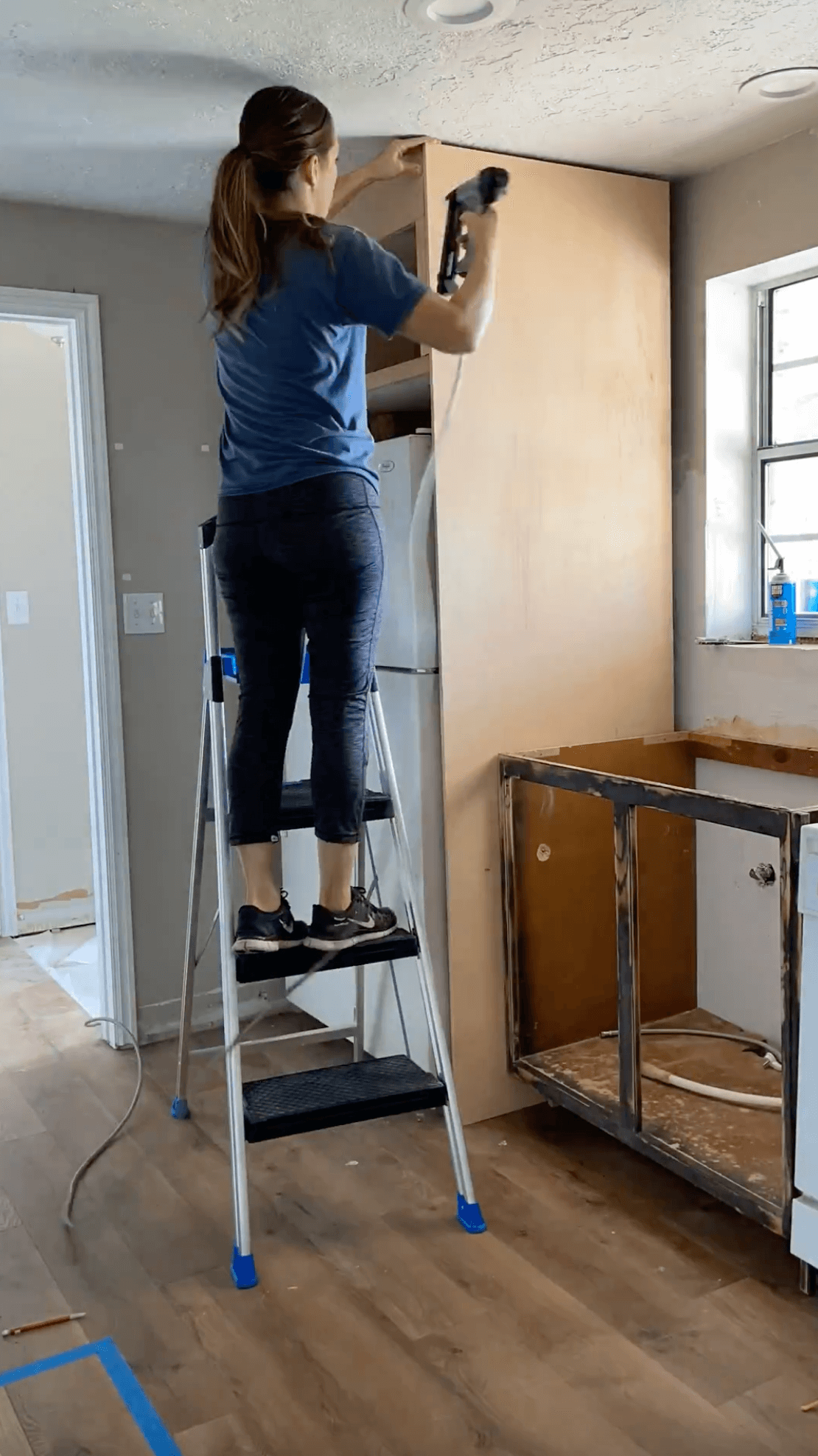 Building a refrigerator cabinet during a DIY kitchen remodel.